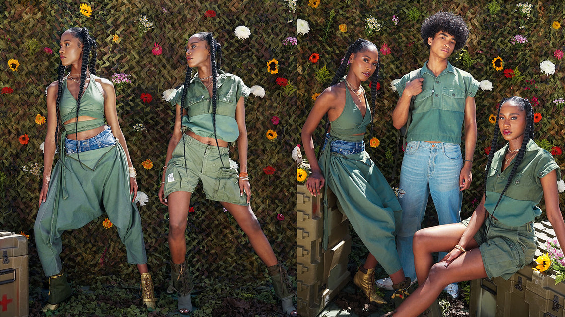 Two woman standing side by side one wearing a green halter bralette in army green that wraps around the waist and a harem pant with a denim waist, the second woman is wearing a repurposed short sleeve cropped military shirt and slouchy cargo shorts, the young man standing between them is wearing the same repurposed short sleeve cropped military shirt and medium light vintage blue jeans